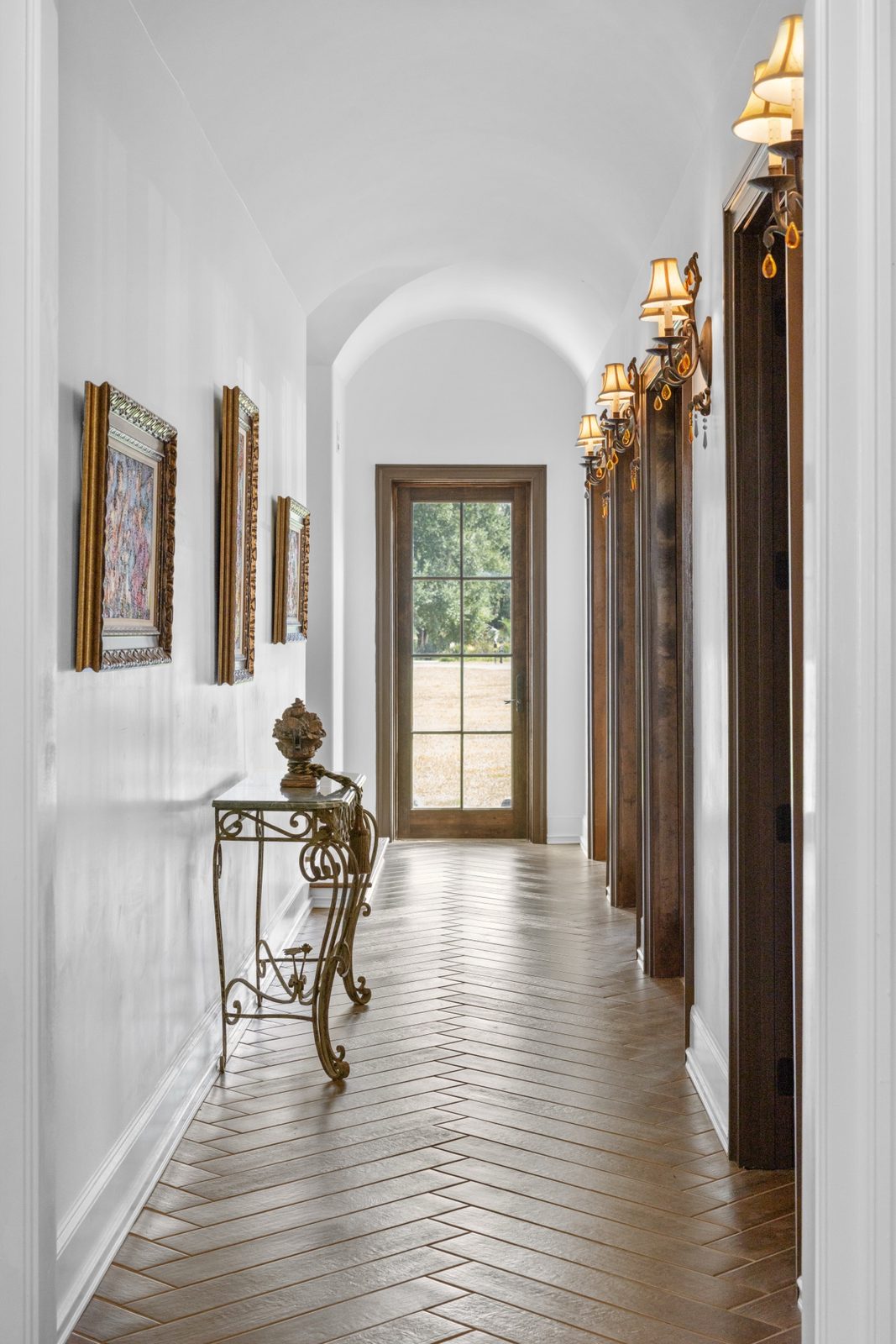 Arched hallway with herringbone wood floor